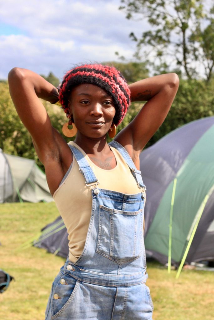 Person holding their arms up in a field