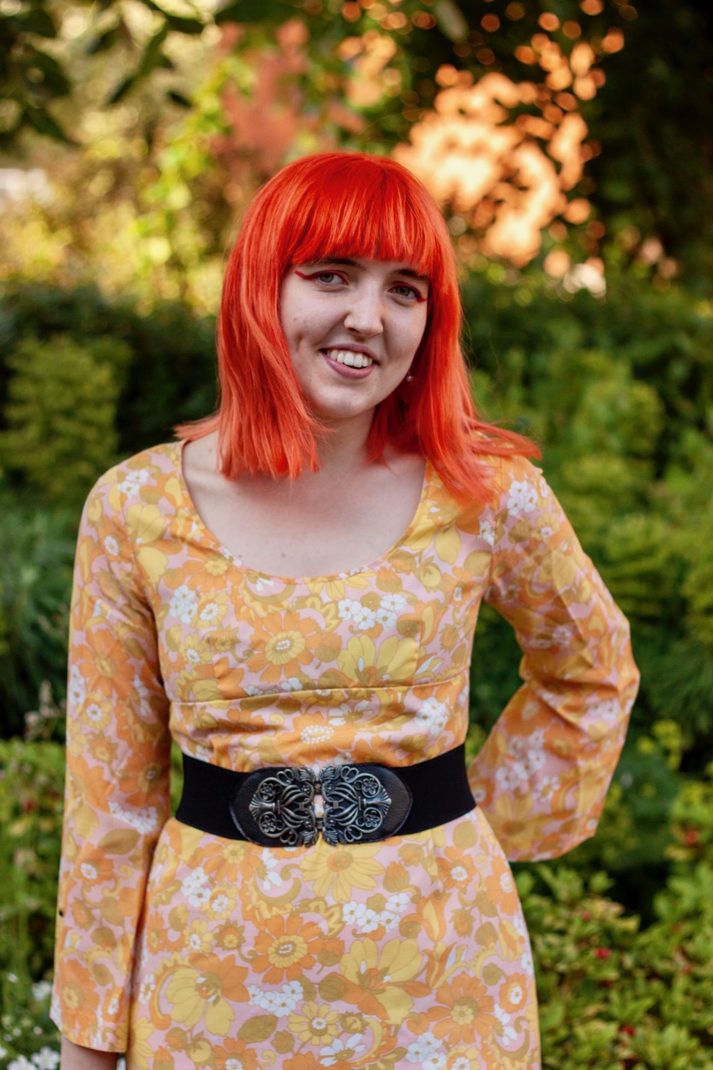 Person with orange hair and yellow dress